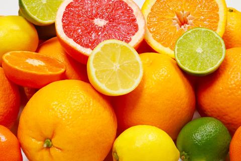 Assorted whole and sliced citrus fruits