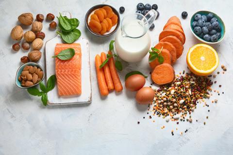 Variety of vitamin- and mineral-rich foods, including salmon, eggs, milk, nuts, spinach and oranges