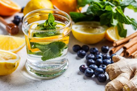 Assorted immune boosting foods, with ginger, citrus, blueberries and spinach