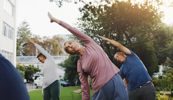 People doing group yoga outside